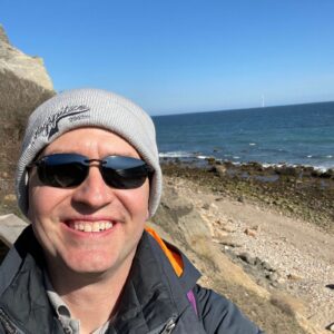 1708779673954 Author, Brandon Jenkins, outside on the shore on a sunny day. Clarity.