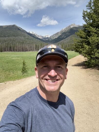 Author and Coach, Brandon Jenkins, walking a path with mountains in the background. He writes about uncovering your Blueprint.