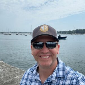 1720612503170 Photo of Author and Coach, Brandon Jenkins, standing on a pier. He writes about expert coaches.