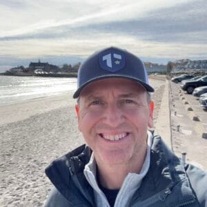 1732151539174 Author and Coach, Brandon Jenkins, pictured on a beach and wearing a Tier One hat. He writes about career transition.