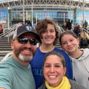 Coach Brandon Jenkins, pictured with his family, making dreams come true.