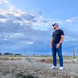 Coach Brandon Jenkins, pictured outside on a partly cloudy evening. He writes about when achievement stops being enough.