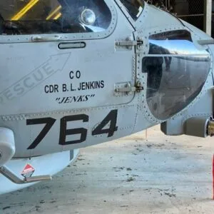 Coach Brandon Jenkins writes about what comes first in new leadership roles. The picture shows his name on the side of a military helicopter.