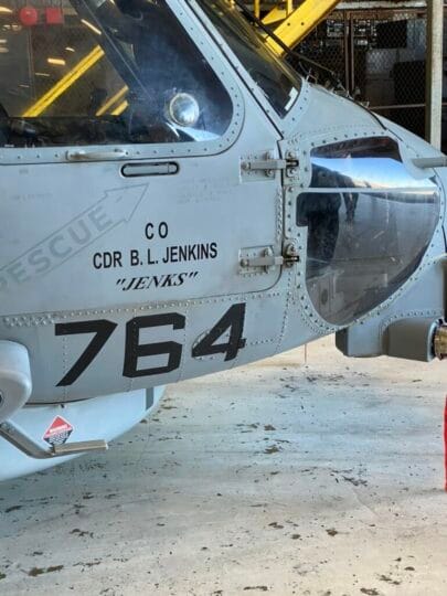 Coach Brandon Jenkins writes about what comes first in new leadership roles. The picture shows his name on the side of a military helicopter.
