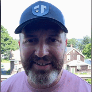 Coach Brandon Jenkins writes about the life you're meant to live. He is pictured outside, wearing a Tier One hat.