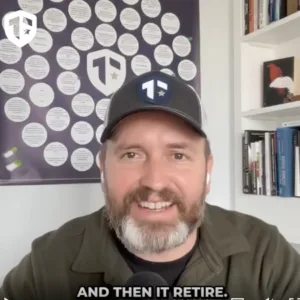 Coach Brandon Jenkins speaks and writes about the fog of transition. He is pictured in his office, wearing a green shirt and a Tier One hat.
