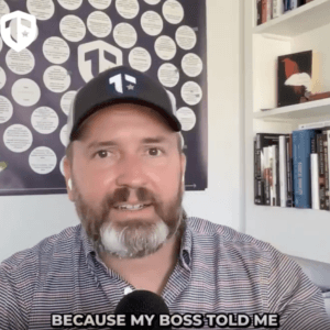 Coach Brandon Jenkins writes and speaks about opening your calendar. He is pictured in his office in front of his Blueprint.