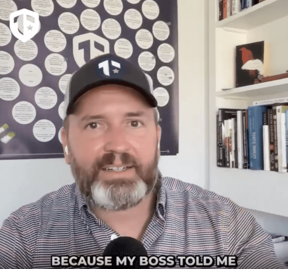 Coach Brandon Jenkins writes and speaks about opening your calendar. He is pictured in his office in front of his Blueprint. 