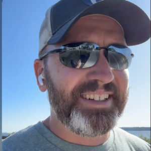 Coach Brandon Jenkins chats about moving up a level. He is pictured on a walk outside.