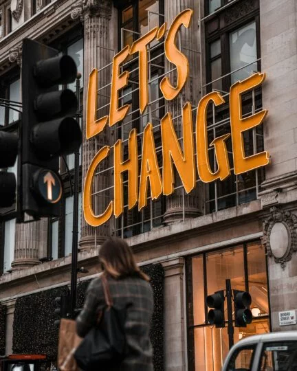 Sign reads "Let's Change." Author Brandon Jenkins writes about change and discovering your Blueprint. 