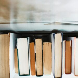 joyce-hankins-CoykYnIunUg-unsplash-2 Stack of books pictured, from above. Author and coach Brandon Jenkins writes about how reading alone won't cut it.