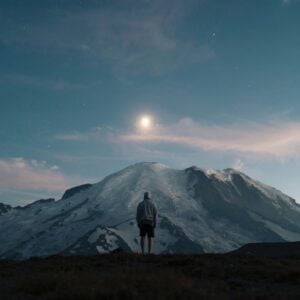 kyle-johnson-Aq7id0ZjEW4-unsplash Author, Brandon Jenkins, writes about leaders embracing humility. Photo shows a person in front of a mountain under moonlight.