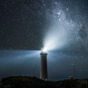 Author and Coach, Brandon Jenkins, writes about using your Blueprint to find certainty. Picture shows a lighthouse at night with stars in the background.