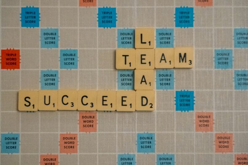 Coach Brandon Jenkins writes about the importance of having a peer coaching group. Image shows a Scrabble board with the words Lead, Team and Succeed.
