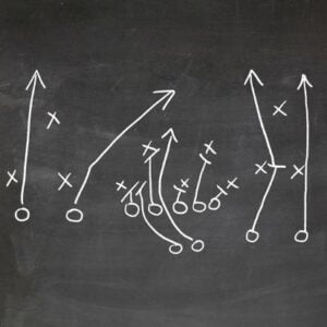 phase4photography-football-play-strategy-drawn-out-on-a-chalk-board_u-l-pn1mxs0 A black and white image of an American Football play. Author, Brandon Jenkins, writes about leading with a coaching mindset.