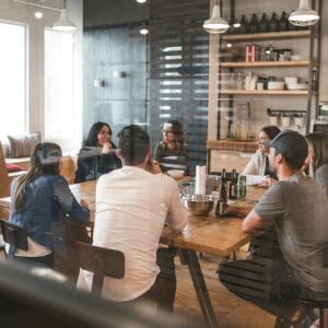 redd-francisco-5U_28ojjgms-unsplash Author and Coach, Brandon Jenkins, writes about how leaders can better handle bad news from teammates. Image shows a team meeting around a rectangle table.